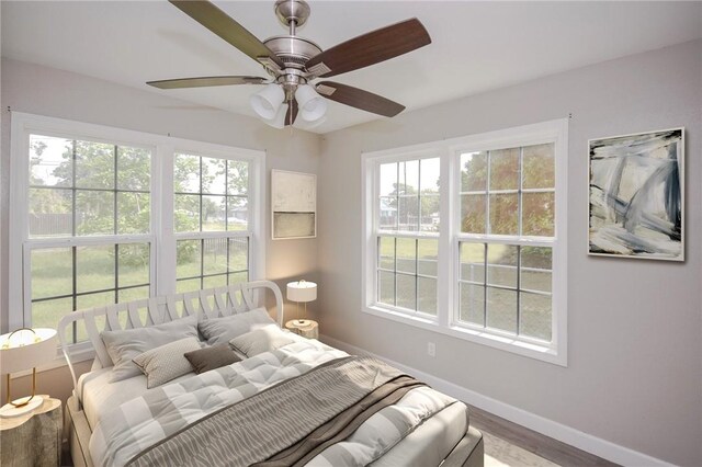 105 E Cornwall St, Rockport, TX 78382 - bedroom with baseboards, multiple windows, and wood finished floors