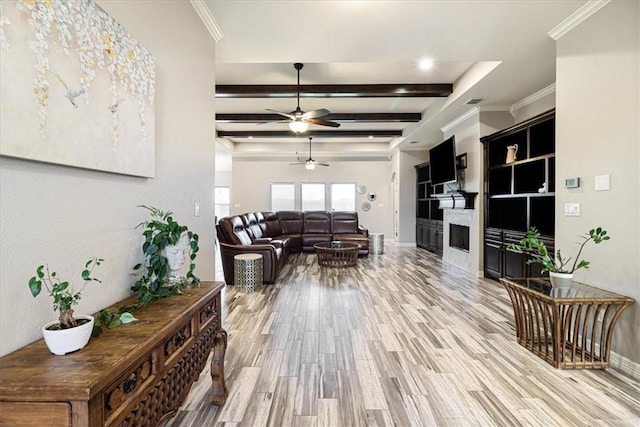 living area with baseboards, ceiling fan, a fireplace, and light wood-type flooring