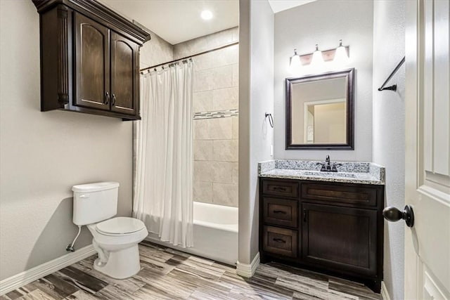 bathroom with wood finished floors, baseboards, vanity, toilet, and shower / bath combo with shower curtain