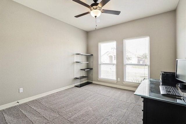 carpeted office with baseboards and ceiling fan