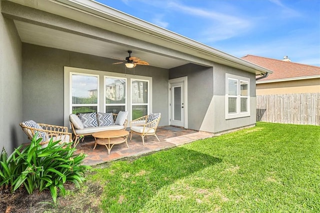 rear view of house featuring a ceiling fan, a lawn, a patio area, fence, and stucco siding