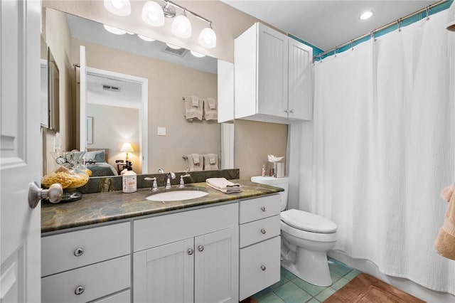 bathroom with visible vents, toilet, connected bathroom, tile patterned flooring, and vanity