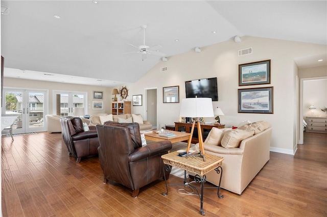 living area with a ceiling fan, wood finished floors, visible vents, high vaulted ceiling, and french doors