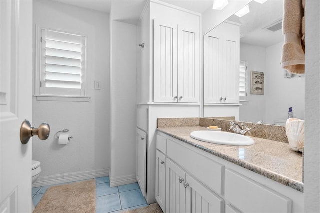 bathroom featuring tile patterned flooring, visible vents, baseboards, toilet, and vanity