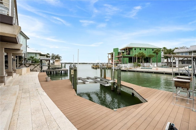 dock area with a water view and boat lift