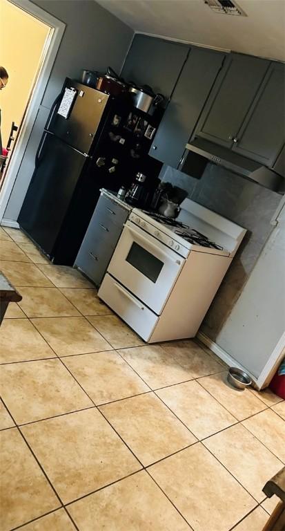 kitchen with gas range gas stove and light tile patterned floors