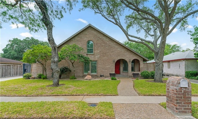 view of front of property with brick siding and a front lawn