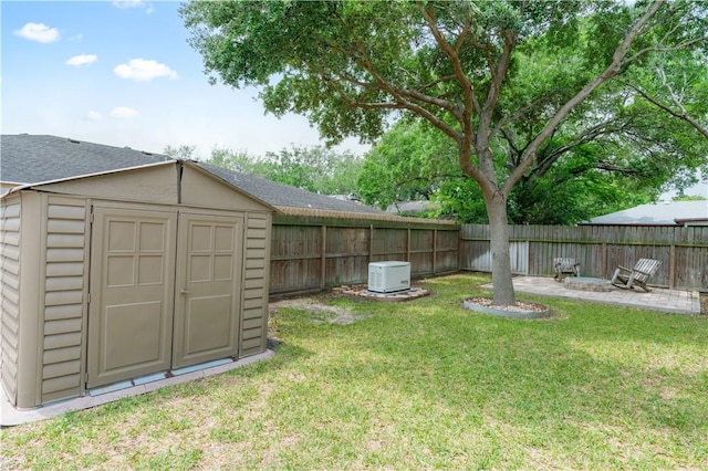 view of yard featuring an outbuilding, a shed, and a fenced backyard