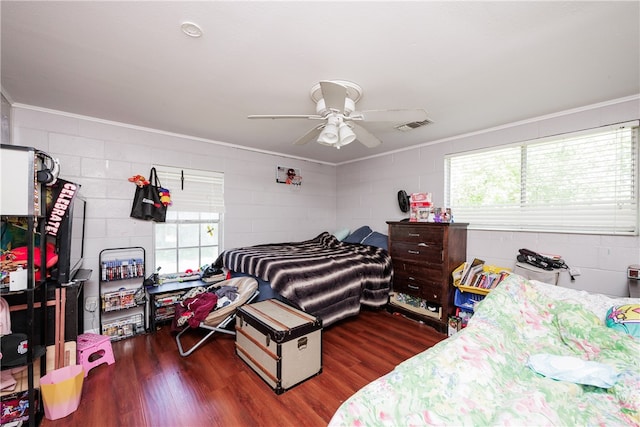 bedroom featuring ceiling fan, multiple windows, dark hardwood / wood-style flooring, and ornamental molding