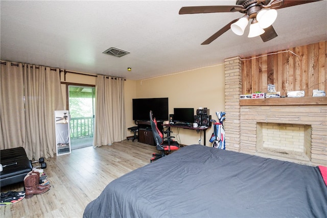 bedroom with light hardwood / wood-style floors, ceiling fan, a textured ceiling, and access to outside