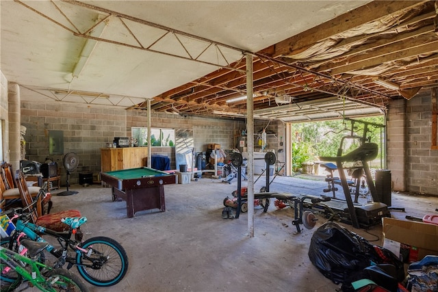 interior space featuring electric panel, concrete flooring, and billiards