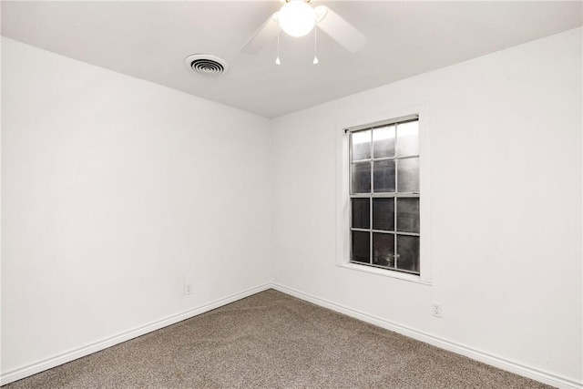 empty room with ceiling fan and carpet flooring