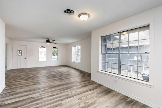 unfurnished living room featuring ceiling fan and light hardwood / wood-style floors