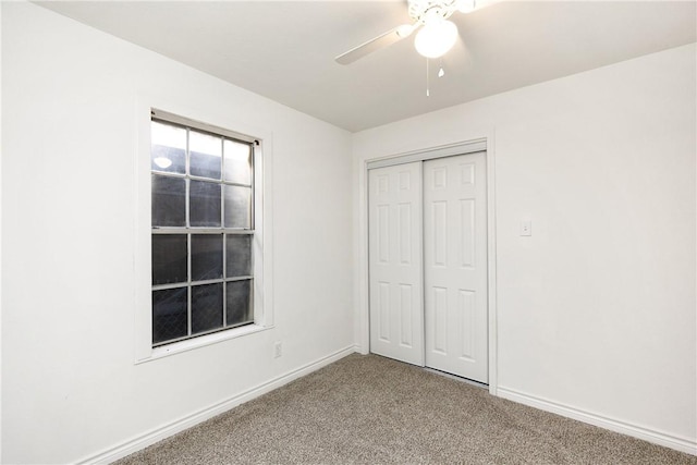 unfurnished bedroom featuring carpet floors, ceiling fan, and a closet