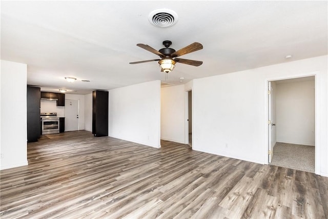 unfurnished living room featuring ceiling fan and light wood-type flooring