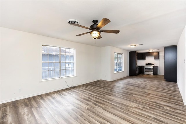 unfurnished living room featuring ceiling fan and light hardwood / wood-style floors