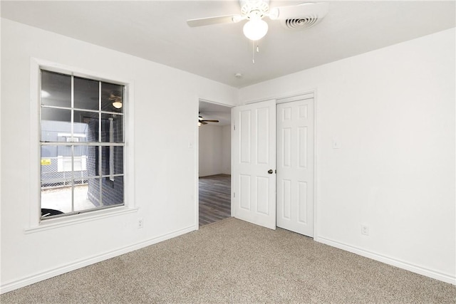 unfurnished bedroom featuring ceiling fan, a closet, and carpet flooring