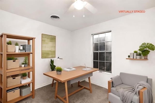 carpeted office space with ceiling fan