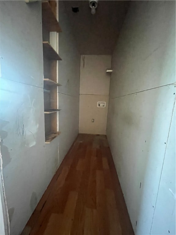 hallway with dark hardwood / wood-style flooring