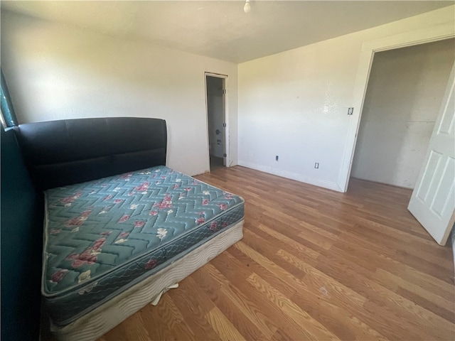 bedroom with hardwood / wood-style flooring