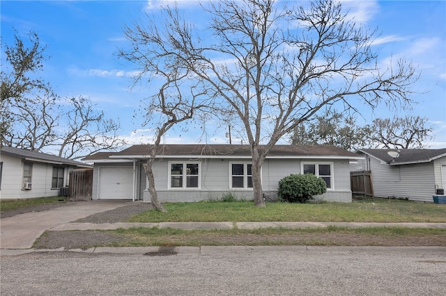 view of front facade with brick siding, a front yard, fence, a garage, and driveway