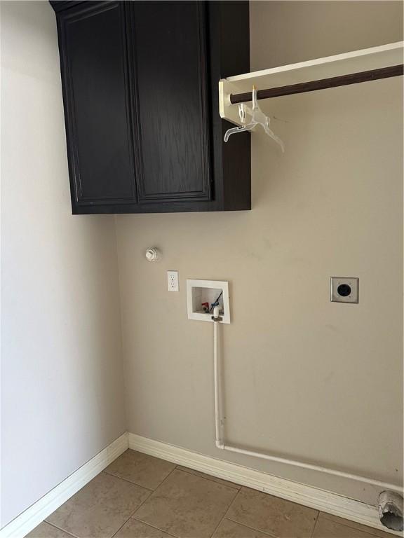 2818 Lake Rhapsody Dr, Corpus Christi, TX 78414 - washroom with hookup for an electric dryer, washer hookup, light tile patterned floors, and cabinet space