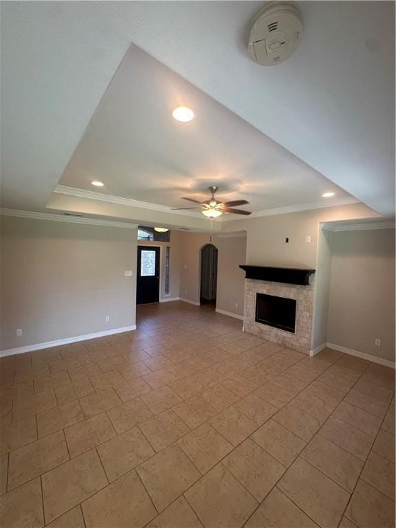 2818 Lake Rhapsody Dr, Corpus Christi, TX 78414 - unfurnished living room with a ceiling fan, a tray ceiling, a fireplace, ornamental molding, and recessed lighting