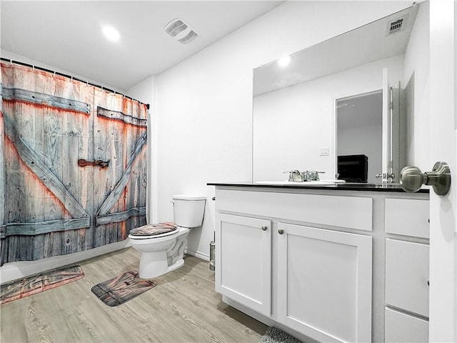 3221 Wrangler St, Corpus Christi, TX 78410 - bathroom featuring vanity, wood finished floors, recessed lighting, and a shower with shower curtain