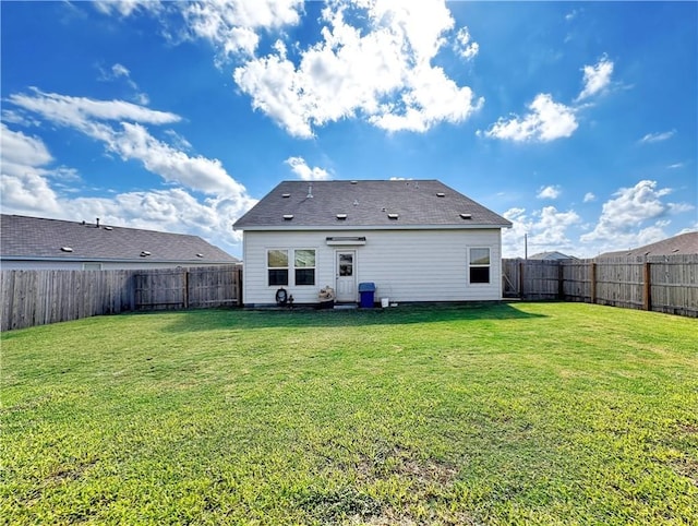 rear view of house featuring a lawn