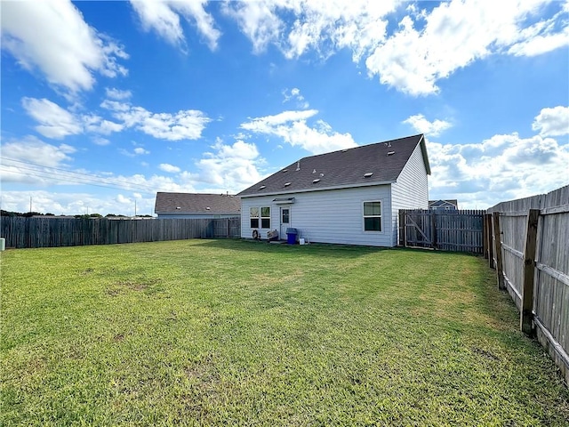 rear view of property with a yard