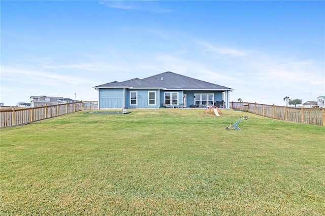 rear view of house with a yard