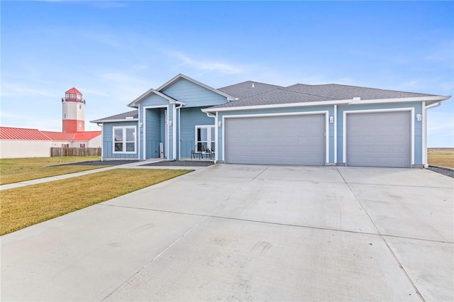 view of front of house with a front yard and a garage