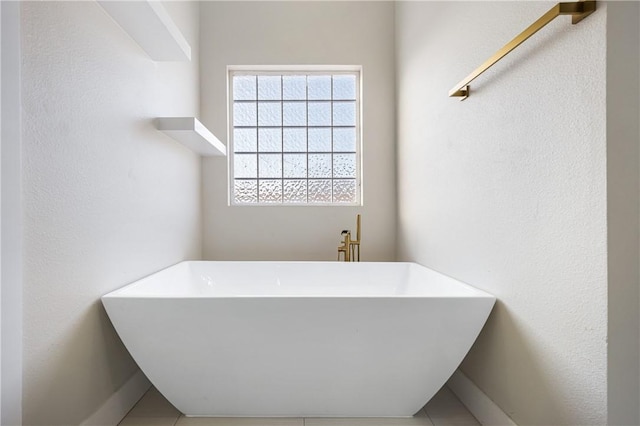 full bath featuring a freestanding tub