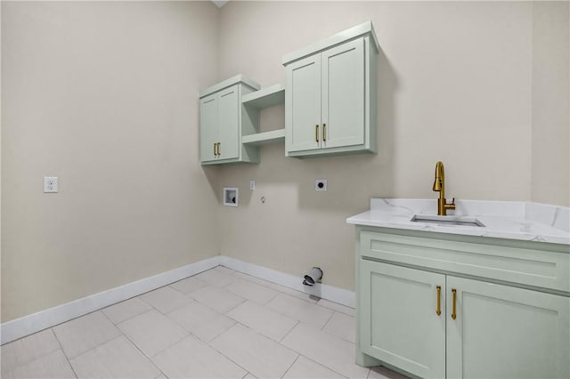 washroom featuring hookup for a washing machine, baseboards, hookup for an electric dryer, cabinet space, and a sink