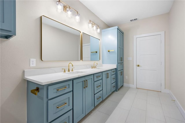 bathroom featuring double vanity, baseboards, visible vents, and a sink