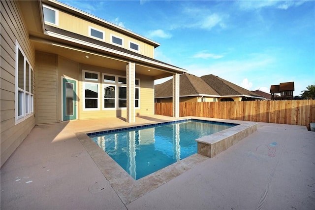 view of swimming pool featuring a patio area, a fenced in pool, and fence