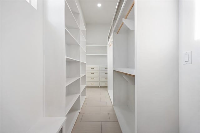 walk in closet with tile patterned floors