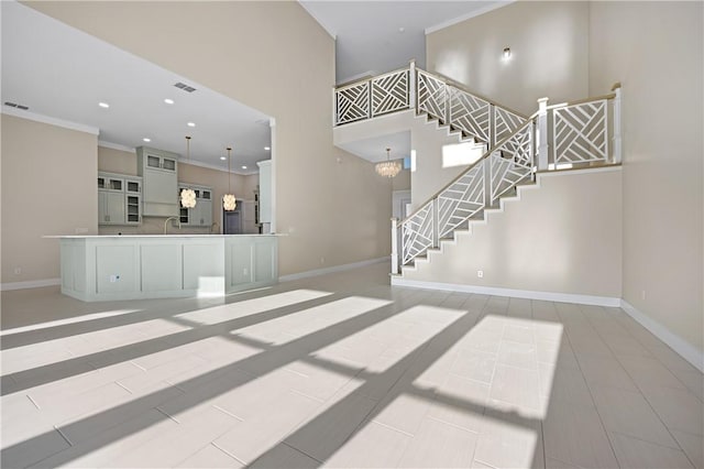 interior space with stairway, recessed lighting, a high ceiling, and baseboards