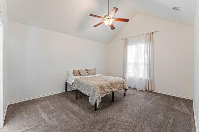 bedroom with baseboards, visible vents, carpet floors, and lofted ceiling