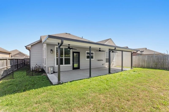 back of house with a lawn, a patio, a ceiling fan, and a fenced backyard