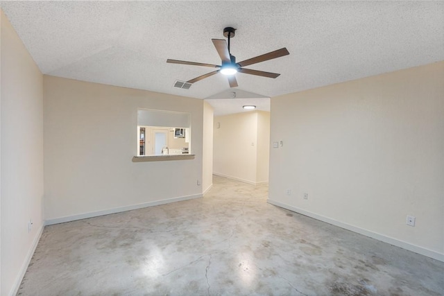 empty room with vaulted ceiling, ceiling fan, and a textured ceiling