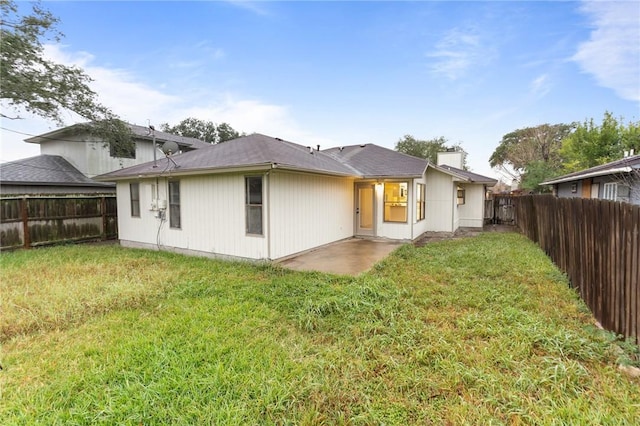 rear view of property with a patio area and a lawn