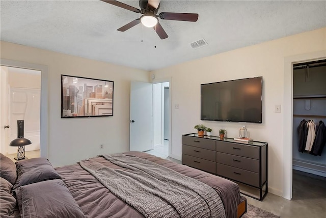 bedroom with ceiling fan, a closet, and a textured ceiling