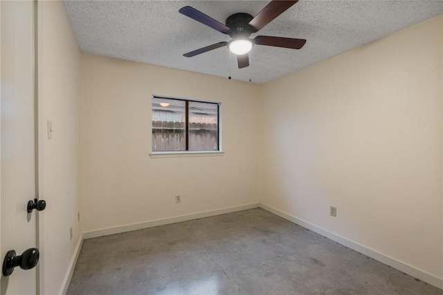 empty room featuring ceiling fan and a textured ceiling