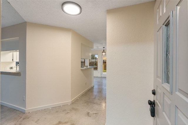 corridor with a textured ceiling