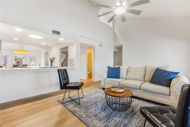 living area featuring light wood-style floors, stairs, visible vents, and recessed lighting