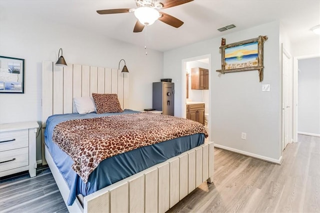 109 Misty Ln, Aransas Pass, TX 78336 - bedroom with light wood-style flooring, ceiling fan, baseboards, and ensuite bathroom