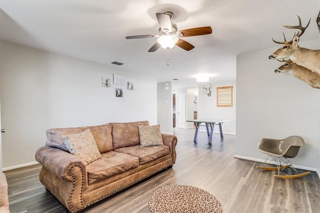 109 Misty Ln, Aransas Pass, TX 78336 - living room featuring a ceiling fan, baseboards, and wood finished floors