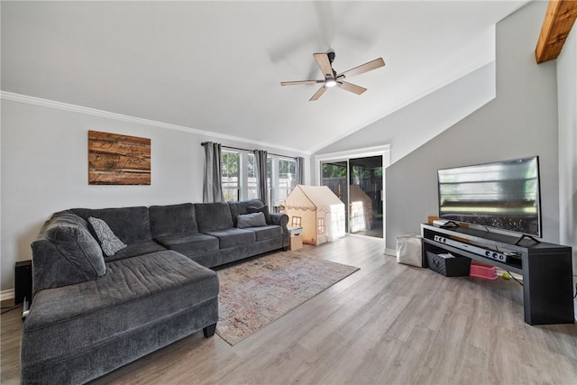 living room with ceiling fan, wood finished floors, baseboards, vaulted ceiling, and crown molding