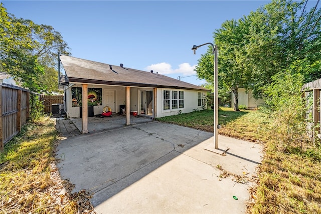 back of house featuring a patio area, cooling unit, and a lawn